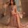 A woman poses elegantly in a chinese silk lingerie set, featuring a delicate floral embroidery and sheer fabric design, embod...