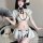 A woman models a classic chinese qipao lingerie set, featuring a delicate white design with black accents, perfect for seduct...