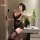 Woman in black lace bodycon mini dress with garter stockings, holding paddle and phone, styled as seductive secretary lingeri...
