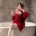 Woman in red feiniao moon-gazing hanfu lingerie set with sheer sleeves, holding wine glass by bathtub.
