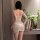 Woman wearing feiniao moonlit bird lace chemise, back view showing floral jacquard and bodycon fit in soft lighting.
