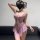 Woman wearing pink floral lace lingerie sleepwear set with sheer mesh and push-up bodysuit design.