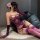 Woman wearing purple floral moon lace lingerie set with sheer backless design, long gloves, and thigh-high stockings.