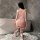 A woman stands by a bathtub wearing a pink flybird moon gazer cosplay outfit, featuring delicate lace details and a sweet des...