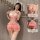Woman modeling a pink french-style lace corset top with push-up cups and a bow, paired with a cherry cake dress.