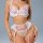 Woman wearing french style lace lingerie with floral embroidery, enhancing small bust, featuring exotic print and delicate de...