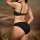 Woman wearing black french-style sheer lace lingerie set, ultra-thin two-piece sensual underwear, back view with elegant stra...