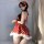 A woman models a festive red polka dot dress with white fur trim, paired with matching bralette and headband, perfect for new...