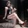 Woman in golden night sexy secretary costume with bodycon mini skirt, seductive lingerie set for playful elegance.