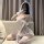 A woman poses in a sensual lace lingerie set, featuring a delicate white dress with lace details, perfect for bridal sleepwea...