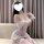 A woman poses in a sensual lace lingerie set, featuring a delicate white design with lace details. the outfit includes a shee...