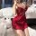 A woman poses in a luxurious red silk sleep dress featuring lace details and built-in pads, exuding elegance and allure. perf...