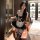 A woman poses in a maid outfit holding a pot, featuring black and white colors with lace details, perfect for evening wear or...
