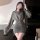 Woman wearing a hong kong style flirty pleated mini skirt with sensual bodycon fit and lace trim corset waistline.