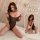 A woman poses wearing a sheer black bodysuit with an open design, featuring a tear-away feature. the outfit highlights elegan...