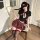 Woman in jin xiao pure-temptation lingerie set with elegant jk skirt and matching bra, posing seductively on chair.