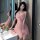 A woman poses elegantly beside a sink, wearing a delicate pink lace cami and matching skirt ensemble from juhuo. the soft fab...