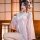 A woman wearing a cute pink kawaii bunny maid costume, featuring a japanese-style sexy sleep robe with rabbit prints, delicat...