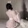 A woman wears a cute pink kawaii bunny maid costume, featuring japanese-inspired design with rabbit prints and bows, perfect ...