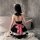 A woman wearing a black and red checkered maid costume with cat ears sits by a bathtub, showcasing a playful yet elegant desi...