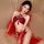 Woman modeling red kouni hanfu lingerie set with sheer sleeves and tang dynasty inspired design on beige bed.