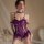 Woman wearing purple lace lingerie set with push-up bust, open-crotch design, and sheer stockings.