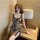 Woman wearing a leopard print lace chemise nightgown with bow details and split front, perfect for bedroom romance.