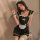A woman wearing a black lolita maid dress with white accents, featuring a bow, apron, and chain accessories, posing elegantly...