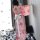 A woman wears a pink floral japanese kimono-style lingerie set, featuring long sleeves and a bow tie, perfect for elegant nig...