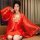 Woman wearing red lace sheer bridal lingerie set with satin goddess robe and long sleeves for romantic nights.