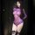Woman wearing purple sheer mesh bodysuit with lace trim, long sleeves, and black bow garters.