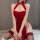 A woman wearing a red lace dress inspired by traditional chinese attire, featuring a high slit and open back design, exuding ...
