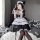 A woman wearing a maid costume cosplay dress, featuring a black and white outfit with ruffles, perfect for anime enthusiasts ...