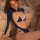 Woman wearing navy blue mannye qing cut-out lingerie set with white trim, featuring open-crotch design and lace details for i...