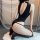 Woman wearing black mannyqing ice silk bodysuit with open back and crotch, kneeling on white rug.