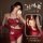 A woman models a red halter bodysuit set with floral embroidery, designed for sensual allure and dance inspiration.