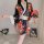 A woman models a muran new japanese kimono-style lingerie, featuring a floral pattern, black satin fabric, and white accents....