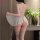 Woman wearing white sheer sleep dress with open back and crotch, lace trim, thigh-high stockings; seductive lingerie for inti...