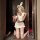 A woman poses playfully wearing a white bunny-themed lingerie set, featuring a bustier top, mini skirt, and stockings, creati...