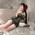Woman posing in sheer black night silk lace cheongsam lingerie set with floral hair accessory, on plush rug.