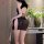 A woman models a black lace cheongsam dress featuring frog buttons and a high slit, exuding elegance and sensuality.