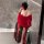 A woman stands by a bathtub wearing a red night silk sensual hanfu lingerie set inspired by cheongsam, featuring a flowing de...