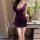 Woman wearing purple night silk sensual lace bodycon dress, holding wine glass, elegant bedroom setting with flowers.