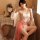 Vintage-inspired sheer lace bodysuit set featuring delicate floral embroidery, paired with a flowing pink skirt, perfect for ...