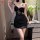 A woman poses elegantly wearing a black lace sleep dress featuring sheer fabric, cut-out details, and adjustable straps, set ...