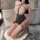Woman kneeling in bathroom wearing nightsigh nightseduce sexy lace bodysuit with sheer polka-dot stockings and strappy design...