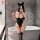 Woman in black nightsigh nightseduce bodysuit with cat ears, posing by bathtub in lace sleepwear uniform.
