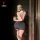 Woman in ol sexy secretarial outfit set with white blouse and gray skirt, posing by a door for a hot date night.