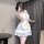 A woman poses with a smartphone, wearing a charming maid outfit featuring a sweet girlie pettiskirt and cupcake skirt. the dr...