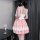 A woman wears a charming pink pettiskirt dress with ruffled details, perfect for curvy women seeking a sweet maid outfit.